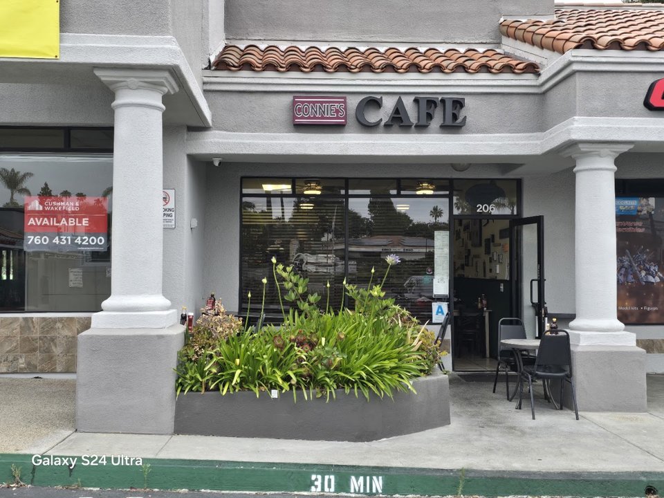 Cozy restaurant dining room with simple tables and chairs.